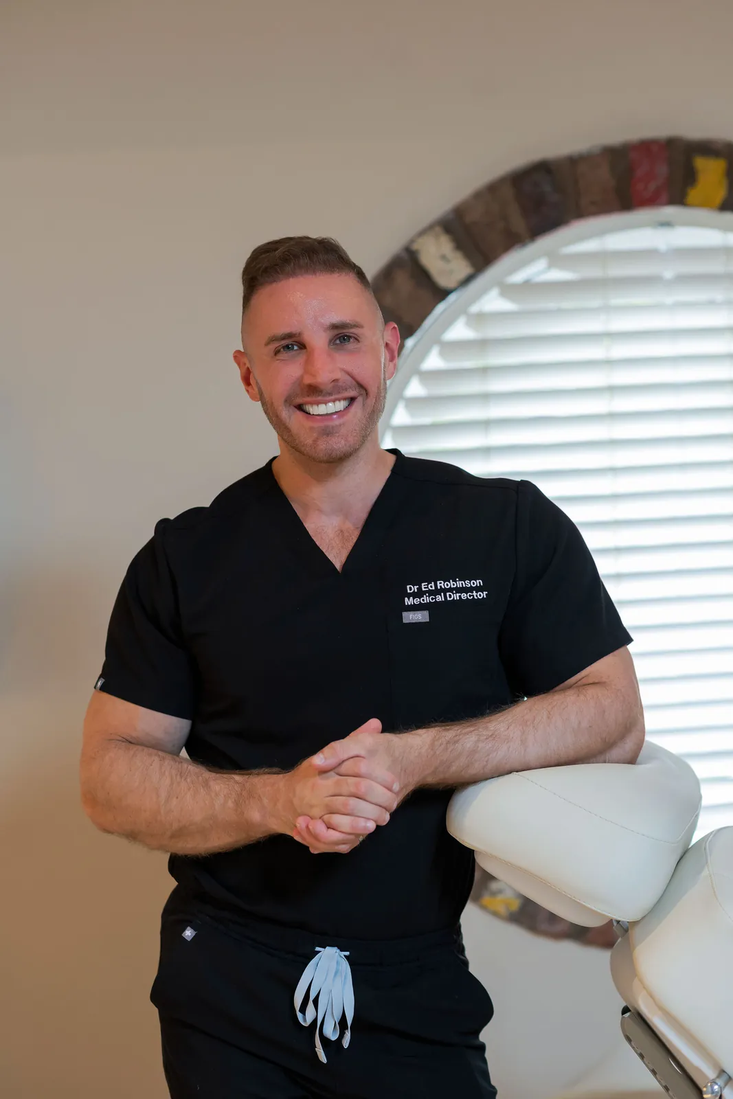 Dr Ed Robinson, Medical Director, standing in a treatment room at Dr Ed Robinson Clinics in Hale